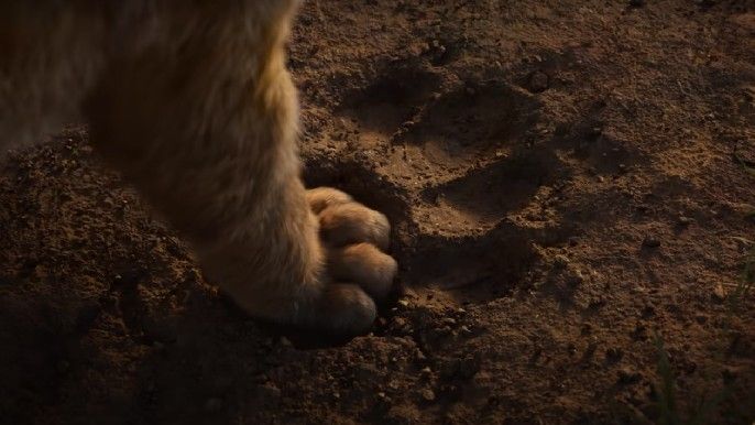 Simba steps on Aaron Pierre as Mufasa paw print on The Lion King