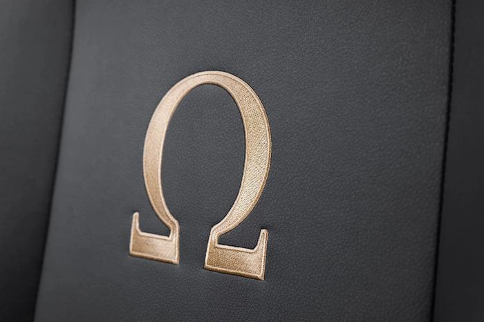 Gold Omega symbol on a black background