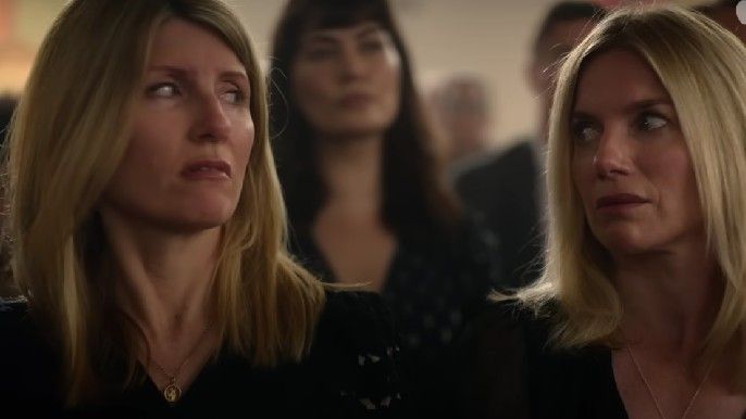 Bad sisters Sharon Horgan as Eva Garvey and Eva Birthistle as Ursula Garvey glance at each other during funeral