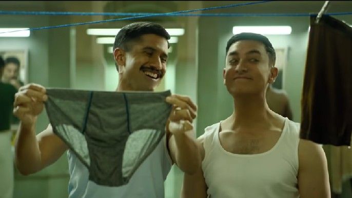 Naga Chaitanya Akkineni as Balaraju 'Bala' Bodi holding up underwear with Aamir Khan as Laal Singh Chaddha in Laal Singh Chaddha