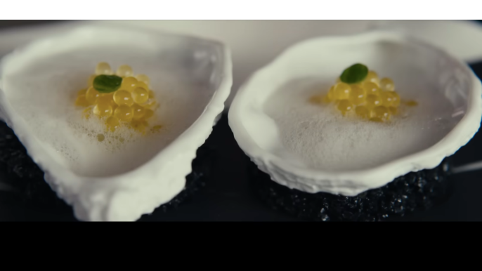 Lemon caviar served on raw oyster with mignonette in The Menu