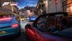 A race at dusk around a Mediterranean style town, with 5 cars jostling for track position