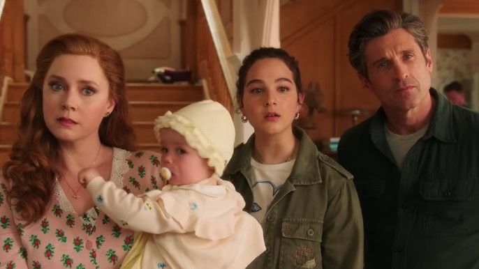 Amy Adams as Giselle holding a baby, Gabriella Baldacchino as Morgan Philip, and Patrick Dempsey as Robert Philip in Disenchanted
