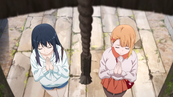 Miko and Hana praying at a shrine.