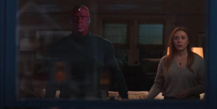 WandaVision Wanda Maximoff and Vision standing side-by-side.