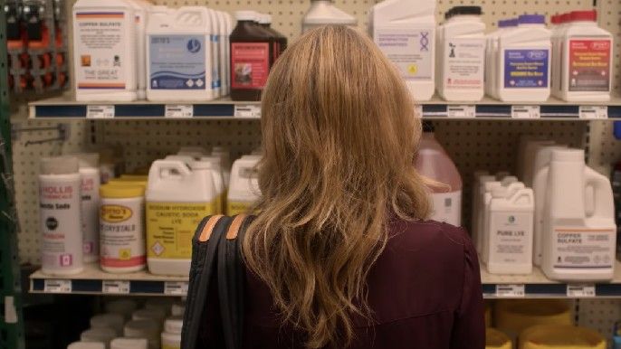 Dead to me season 2 Christina Applegate as Jen Harding looking at cleaning supplies