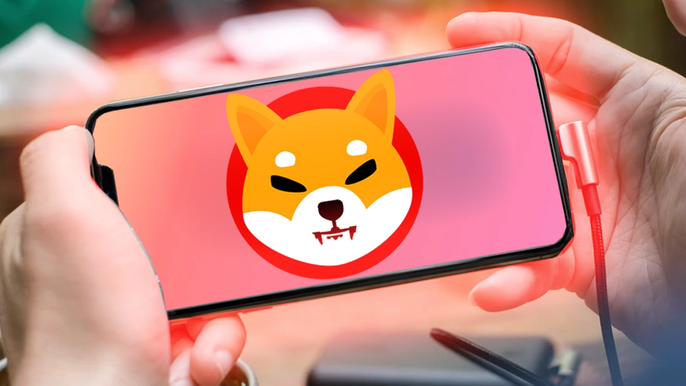 Image of two hands holding a phone with the Shiba Inu logo in the centre on a pink/orange gradient background, with a red glow.