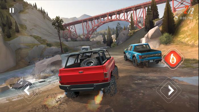 Screenshot from Rebel Racing, showing two trucks driving along a riverside under a bridge
