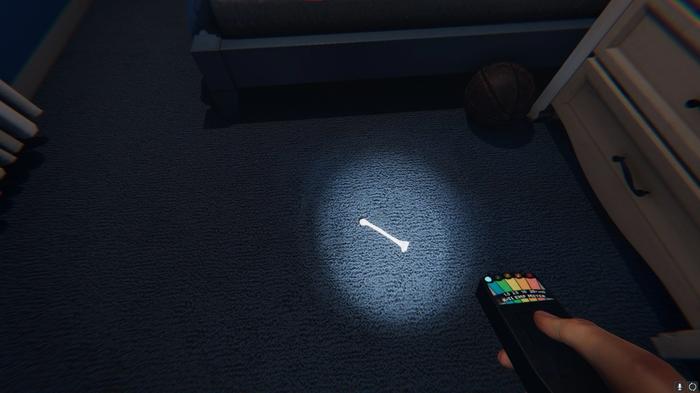Bone Evidence can be seen on the bedroom floor in Phasmophobia, with an EMF Reader pointed at it.