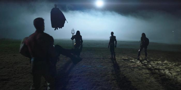 Superman, Aquaman, Flash, and Wonder Woman are in a barn field from Peacemaker's finale.
