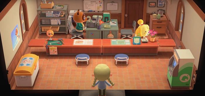 A player, the Resident Representative, is stood in the Town Hall with Tom Nook and Isabelle as she smells flowers.