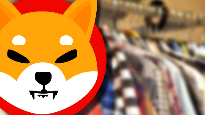 Image of Shiba Inu Logo in front of clothes rack of shirts