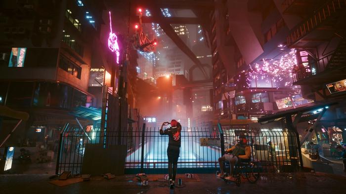 A woman in stood in front of some railings. She's in the middle of a huge, cyberpunk city.