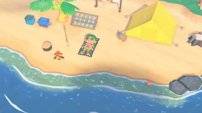 A player lying on the beach of their island beside their tent in Animal Crossing New Horizons.