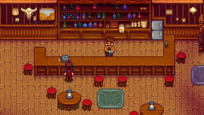 Stardew Valley, Stardrop Saloon. The player is stood at the till on the long wooden bar. The bartender, Gus, is stood behind the bar cleaning a glass.