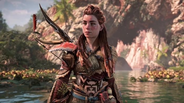Horizon Forbidden West Aloy in new armour standing in the middle of a lake.