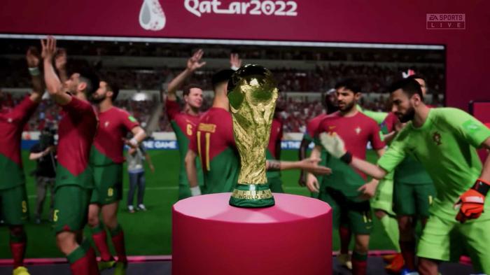 Portuguese players crowding around the World Cup trophy in FIFA 23.