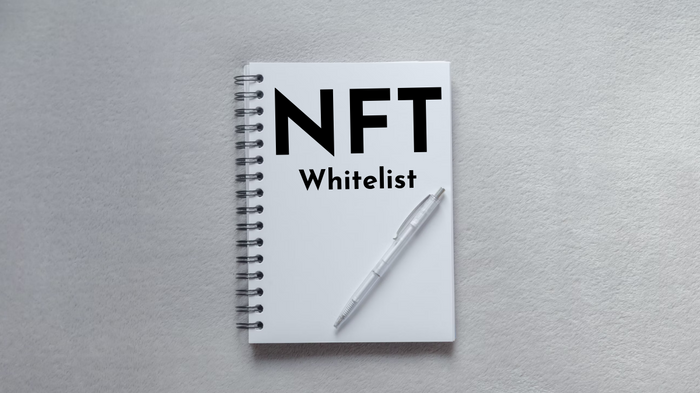 White notebook on white background with NFT whitelist written on the notebook.