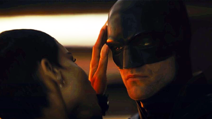 Catwoman is with Batman, caressing his head with her hand.