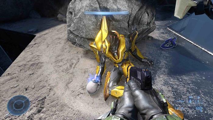The Famine skull on the ground, held by a golden elite enemy in Halo Infinite.