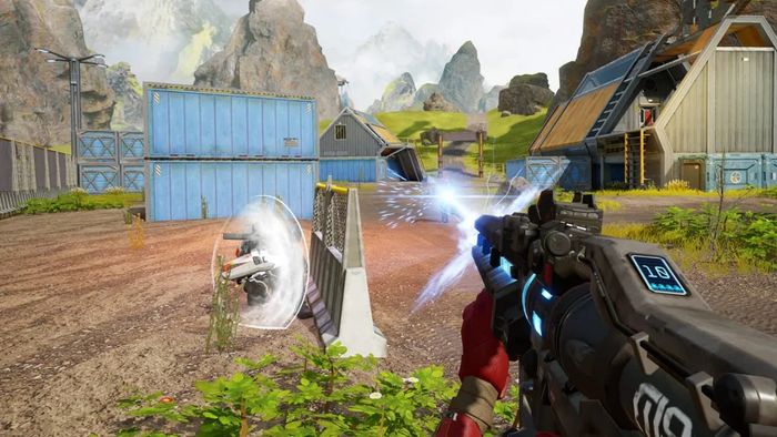 A player shoots their gun at some buildings in Apex Legends Mobile.