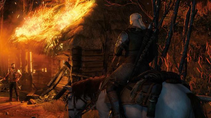 Geralt rides Roach towards a burning thatched cottage in The Witcher 3.