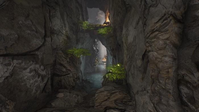 The Forgotten City, the tunnels under the palace. The image shows green plant formations up the sides of the cave walls that can be used as steps to the next area. There is water in the center and a peeled statue.