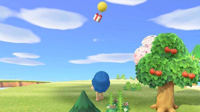 Animal Crossing New Horizons. The player is aiming up at a floating gift. The balloon is yellow. There is a cherry tree on the right of the image.