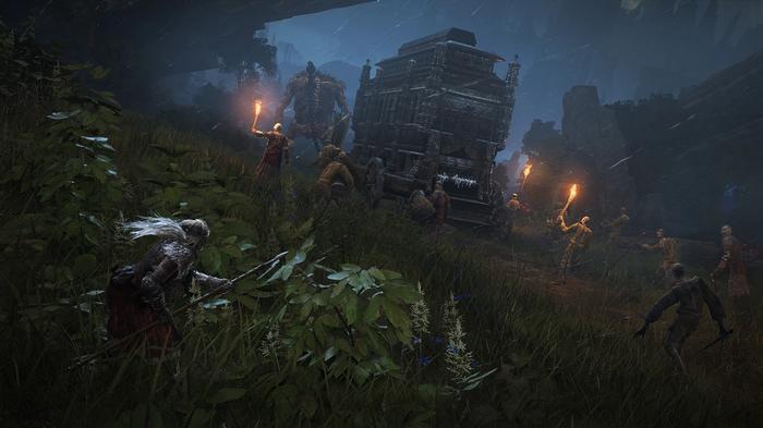 A player approaches a carriage being drawn by a Storm Troll and other enemies at night in Elden Ring.