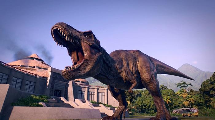 Jurassic World Evolution 2. A T-Rex is roaring in the middle of the image. The T-Rex is outside the visitor center from the original Jurassic Park movie. 