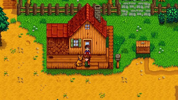 Stardew Valley. Standard Farm in Spring Year 1. The player, Marnie and a dog are standing on the wooden decking of the house. The ground around the farm is bare.