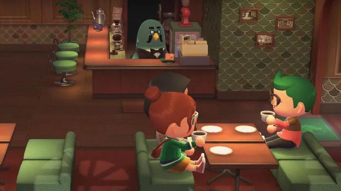 Two players inside The Roost, with Brewster, in Animal Crossing: New Horizons.