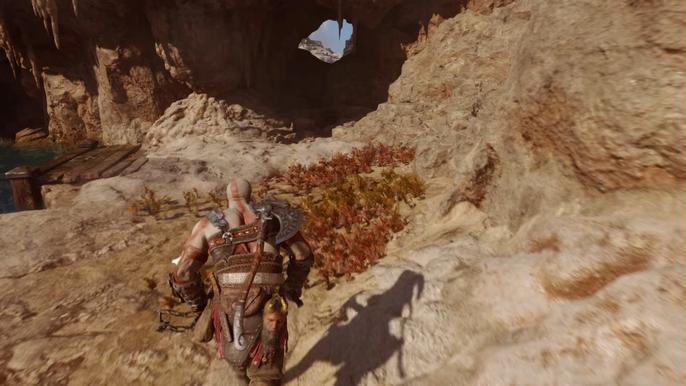 Kratos running through a cave in God of War Ragnarok 