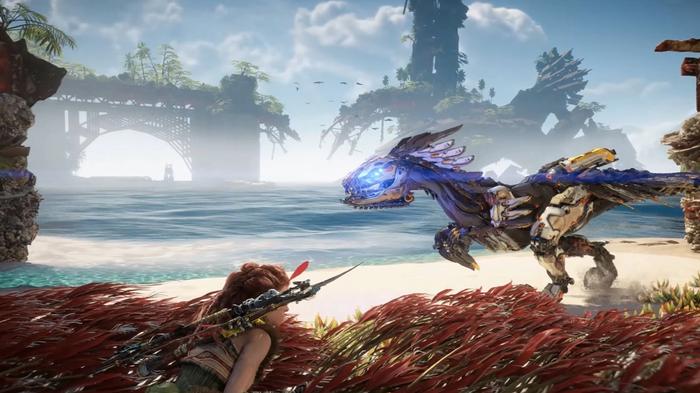 Horizon Forbidden West Aloy hiding in tall grass as a Clawstrider stalks past on the sand.