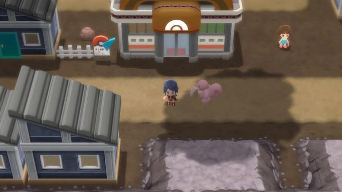 A Pokémon Trainer and their Lickiting standing outside Oreburgh City Gym in Pokémon Brilliant Diamond and Shining Pearl.