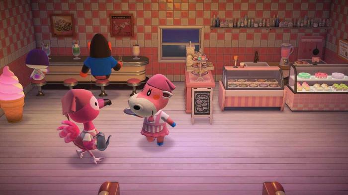 Animal Crossing New Horizons Happy Home Paradise - The Cafe Facility. This cafe has been turned itno a pink ice cream parlour and 50's style diner. The flamingo and cow are to the left of the photo