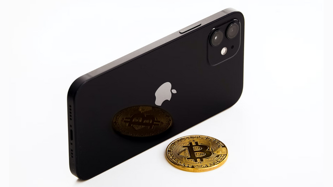 Bitcoin next to a mobile phone iPhone.