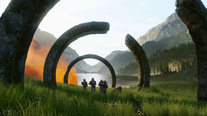 A shattered Halo ring lies on the ground with several Spartans walking in the distance.