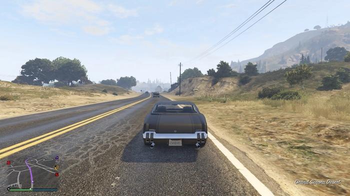 GTA Online. The player is driving a bounty target back to Maude after making them surrender. The car is currently on a road in the Grand Senora desert.