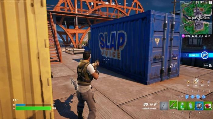The player aiming at a Slap Juice container in Fortnite.