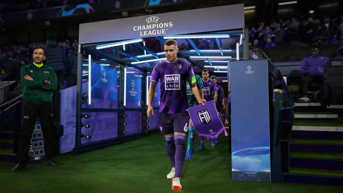A Football Manager 23 player walks out of the tunnel onto the pitch.