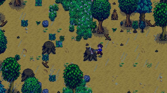 Stardew Valley. The player is using their copper axe to break a large tree stump on their left.