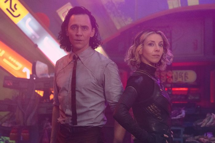 Loki and Sylvie are in a purple, neon-lit area.