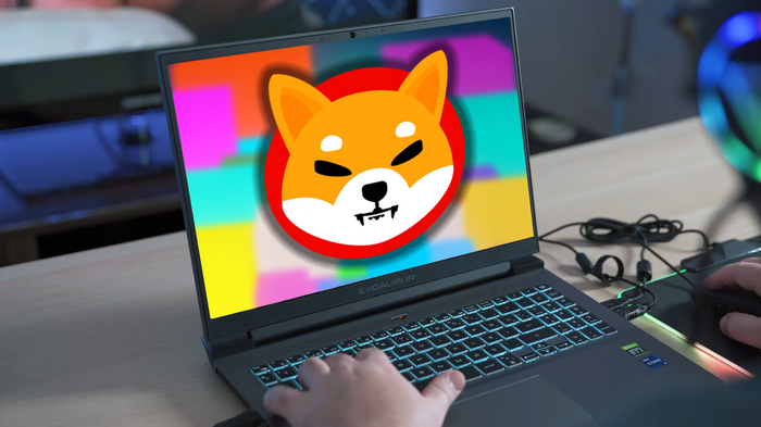 Shiba Inu Logo on a Gaming Laptop with someone playing a game.