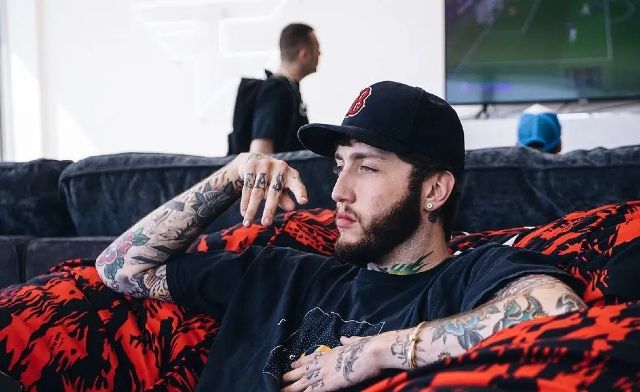 FaZe Banks Posing On Red And Black Couch