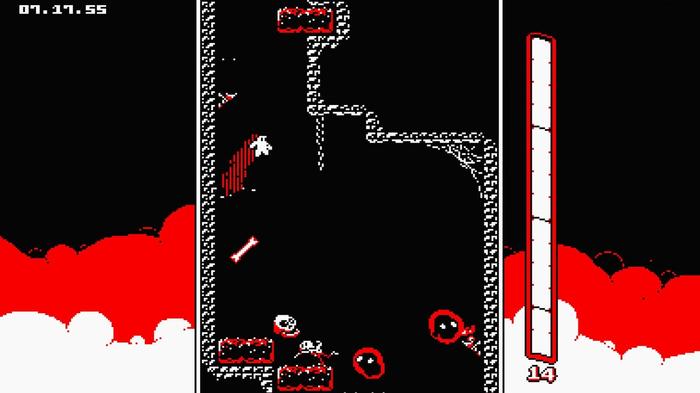 The boy in Downwell dropping down the well with enemies on either side.