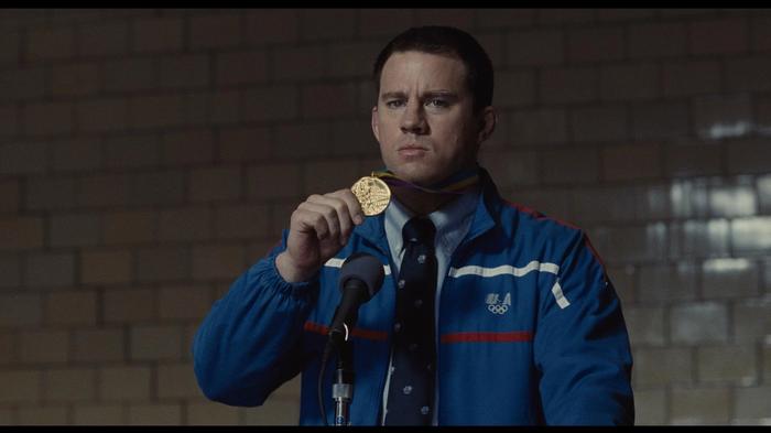 Channing Tatum is holding a medal in Foxcatcher.
