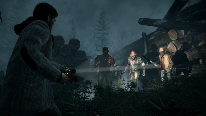 Alan Wake Remastered Screenshot - Alan out in the dark, surrounded by timber stacks. Three Taken wielding weapons about to attack him, flashlight being shone at them.