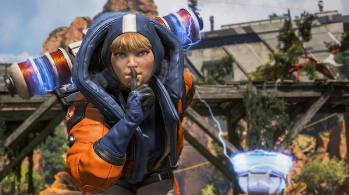 Apex Legends Season 2 Wattson Shhh Screenshot. Wattson can be seen leaning towards the screen doing the "shh" gesture with her fingers to her lips. 