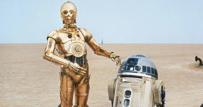 C-3PO and R2-D2 are in the desert.